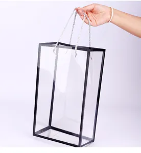 Transparent PVC flower gift bag with black frame and silver handles for bouquet wrapping.