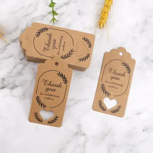 Kraft paper gift tags detail shot, heart cutout design, thank you printing, wedding decor.