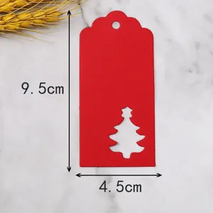 Red paper Christmas gift tag with hollow tree design, perfect for holiday decoration.
