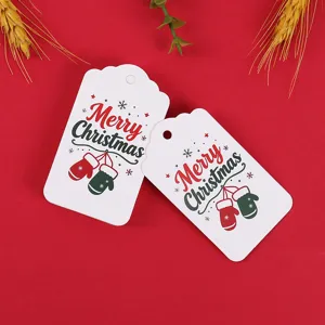 Christmas paper gift tags detail view showcasing cute mitten patterns and festive holiday text.