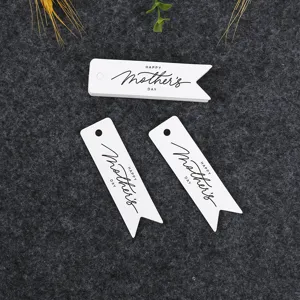 Detailed view of white paper Mother's Day gift tags with swallowtail design and hanging holes.