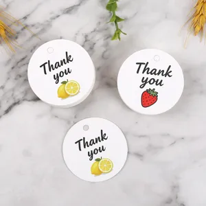 Round paper gift tags with thank you text and cute lemon and strawberry fruit designs for packaging.