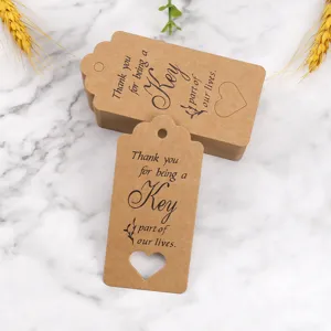 Kraft paper thank you tag detail showing cutout heart design and elegant printed typography for gifts.
