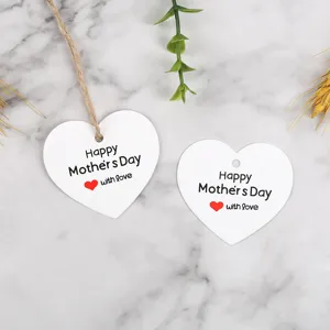 Detailed view of white heart shaped Mother's Day gift tags with twine and lovely text design.