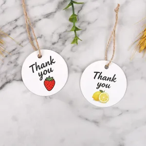 Round paper gift tags with thank you text, strawberry and lemon patterns for package decor.