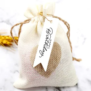 Rustic burlap drawstring gift pouch with happy birthday paper tag for party favors.