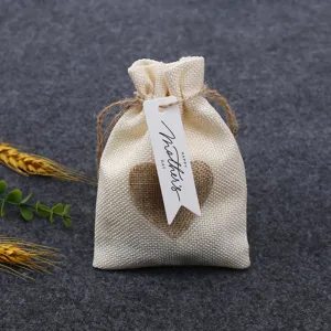 Burlap gift bag with heart decor and Mother's Day tag detail shot for holiday celebration