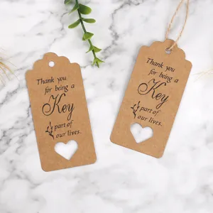 Kraft paper thank you tags with heart cutout and string for gift wrapping packaging detail view.