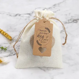 White burlap jute favor gift bag with pull string and brown kraft paper hang tag decoration.