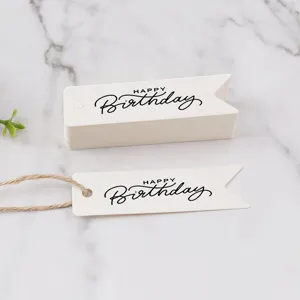 Close-up detail view of white birthday gift tags with happy birthday text and twine rope.