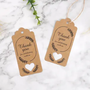 Kraft paper gift tags with heart cutout and thank you print, ideal for wedding party favors.