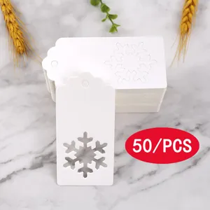White paper gift tags with hollow snowflake pattern, ideal for Christmas packaging and decoration.