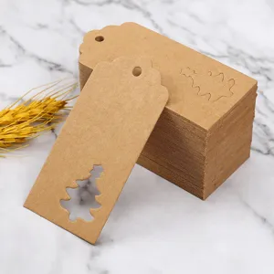 Kraft paper Christmas tree cut-out gift tags, blank holiday favor labels for present.