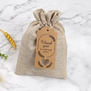 Burlap gift bag with kraft paper thank you tag, rustic drawstring pouch for wedding party favors.
