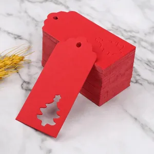 Red paper Christmas gift tags with hollow tree design, perfect for holiday wrapping.