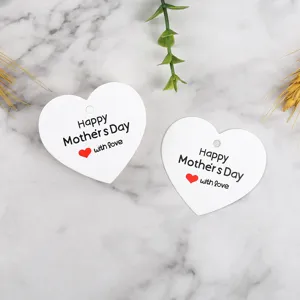 Detailed close-up of heart-shaped white Mother's Day gift tags with lovely text.