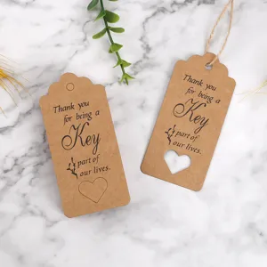 Kraft paper thank you tags gift wrapping labels with heart cutout and string for party favors.