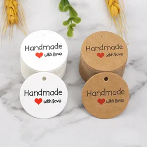 Details of round handmade paper gift tags with lovely heart print for baking packaging decor.