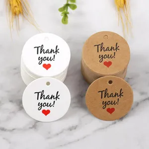 Round paper hang tags with Thank you print, kraft and white labels for bakery gift packing decor.