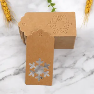Kraft paper Christmas snowflake gift tags detail, blank hanging tag cutout for holidays.
