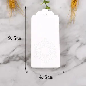 White paper gift tag detail, snowflake cutout design, 9.5x4.5cm decorative holiday label.