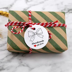 Round white handmade gift tag with bow design, perfect for baking packaging and presents.