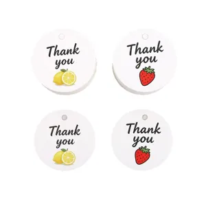 Round paper gift tags with lemon and strawberry fruit designs, thank you hang tags for packaging.