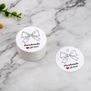 Handmade bow gift tags round white paper labels for baking and gift packaging details.