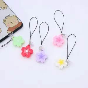 Χρωματιστά λουλούδια PVC charms τηλεφώνου με μαύρα λουριά, χαριτωμένα αξεσουάρ.