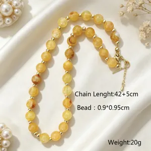 Elegant yellow acrylic beaded necklace with gold spacers, stylish clavicle chain design.
