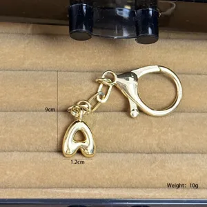 Golden bubble letter A pendant detail shot showing dimensions and weight for bag charm accessory