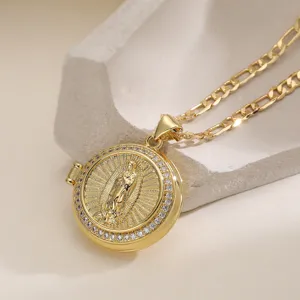 Close-up of a gold-plated locket necklace featuring a sacred motif and sparkling zirconia stones.