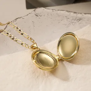 Gold-tone locket pendant necklace detail close-up showcasing the openable oval photo frame design.