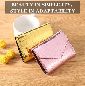 Closeup detail of laser crocodile pattern women wallet card holder in gold and pink colors.