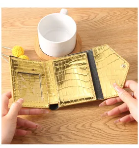 Gold metallic crocodile pattern minimalist women trifold wallet with card slots and id window.