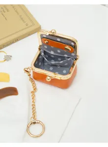 Mini PU leather kiss-lock coin purse, gold chain keyring, cute polka dot lining detail.