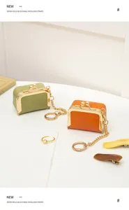 Mini PU leather kiss lock coin purse detail view with metal frame and chain, cute accessory.