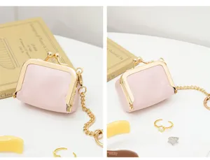 Mini pink PU leather kiss lock coin purse and jewelry box with gold chain strap for women.