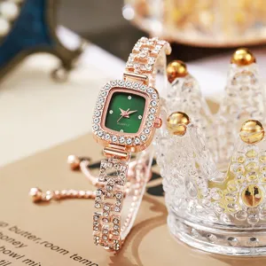 Close-up of rose gold women's watch with green square dial and rhinestone bracelet.