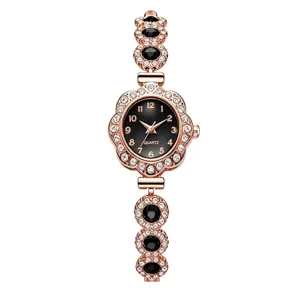 Detailed view of rose gold women's bracelet watch with rhinestones and black gems