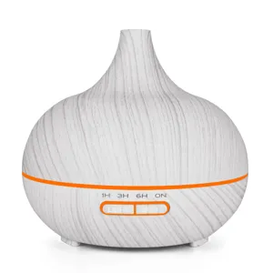 Close-up detail of a white wood grain onion-shaped essential oil diffuser with timer buttons