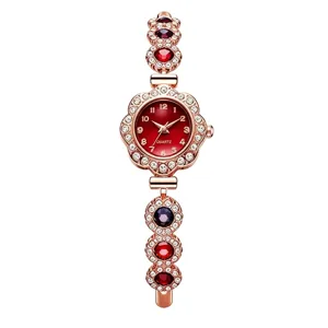 Detailed view of elegant rose gold women's quartz bracelet watch with vibrant red dial