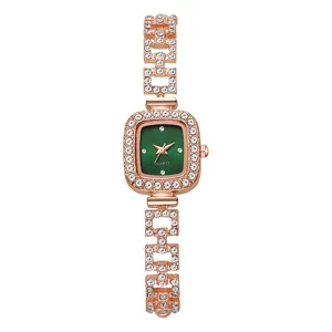 Detailed view of an elegant rose gold square bracelet watch featuring a deep green dial
