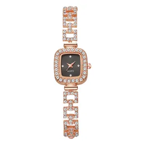 Close-up of rose gold ladies' watch with rhinestone square dial and chain strap