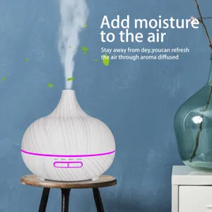 Detailed view of a wood grain essential oil diffuser releasing cool mist on stool