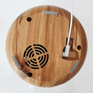 Bottom view of the wood grain essential oil diffuser showing power cord connection