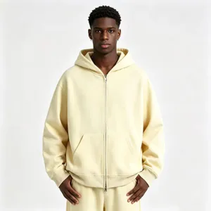 Detail view of heavy full-zip hoodie in cream color, showcasing ribbed cuffs and fabric texture.