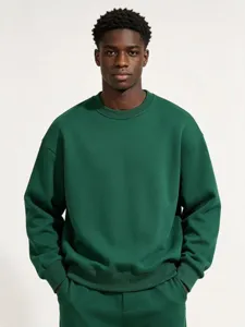Detailed view of dark green crewneck pullover sweatshirt fabric, fit and texture features.