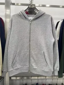 Heavyweight grey zip-up hoodie detail showcasing durable metal zipper and soft loopback fabric.