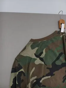 Detailed view of the men's camouflage long-sleeve crewneck t-shirt, casual cotton top.